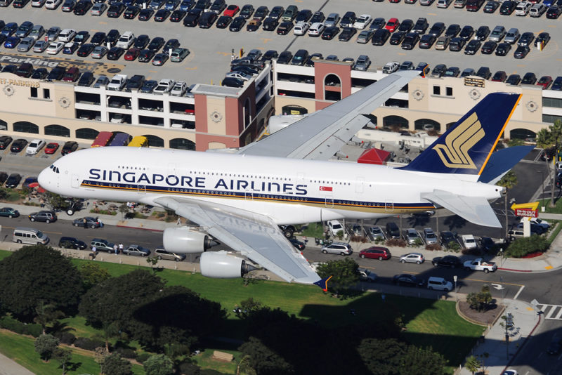 an airplane flying over a parking lot