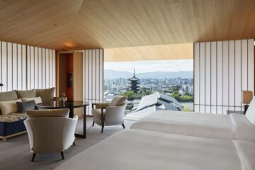 a room with a view of a city and a tall tower