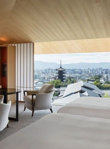 a room with a view of a city and a tall tower