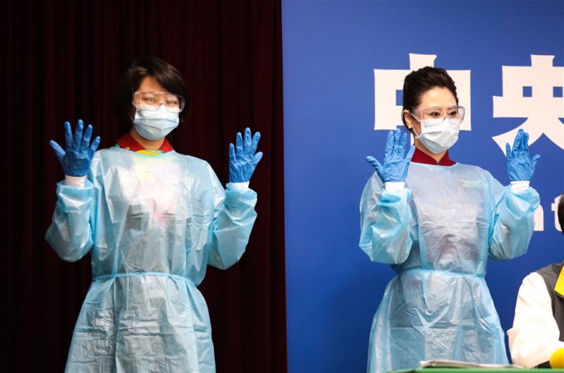 a couple of women wearing surgical gowns and face masks