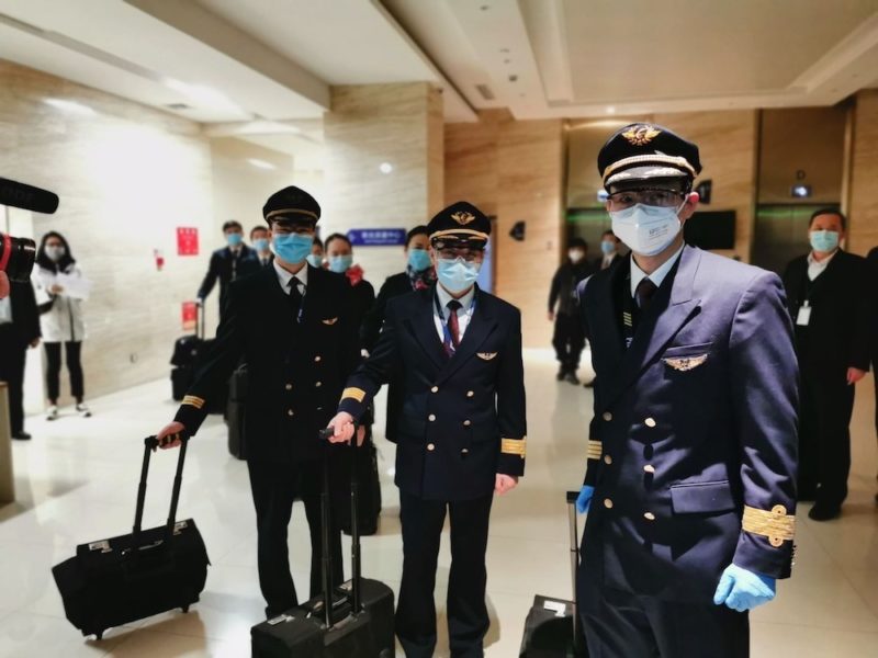a group of people wearing masks and uniforms