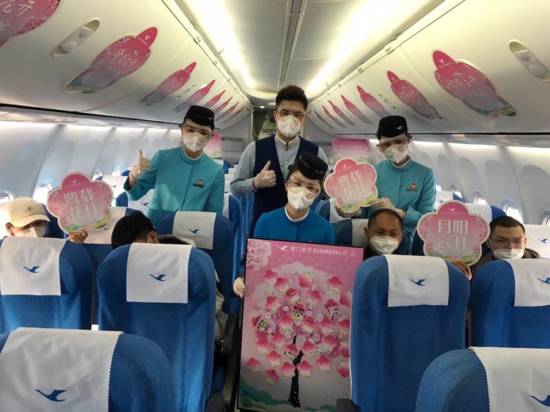 a group of people in a plane with masks