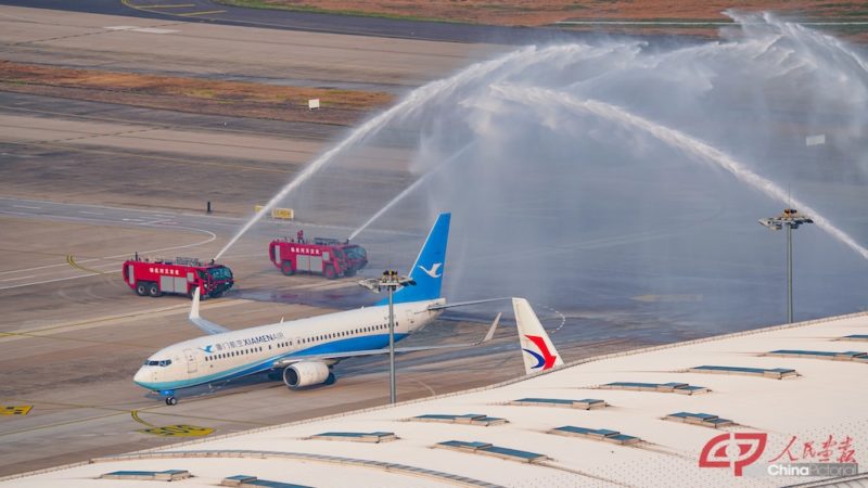 a jet plane spraying water on a runway