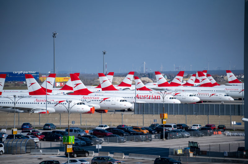 a group of airplanes parked in a parking lot