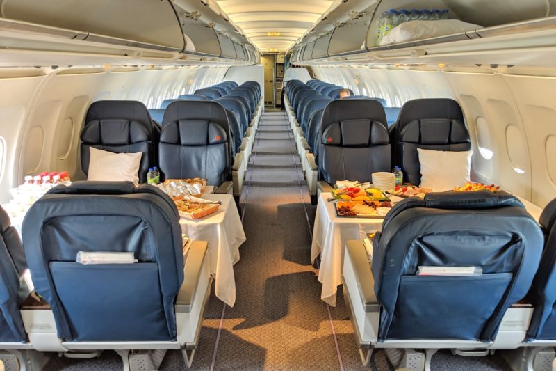 a plane with many seats and food on the table