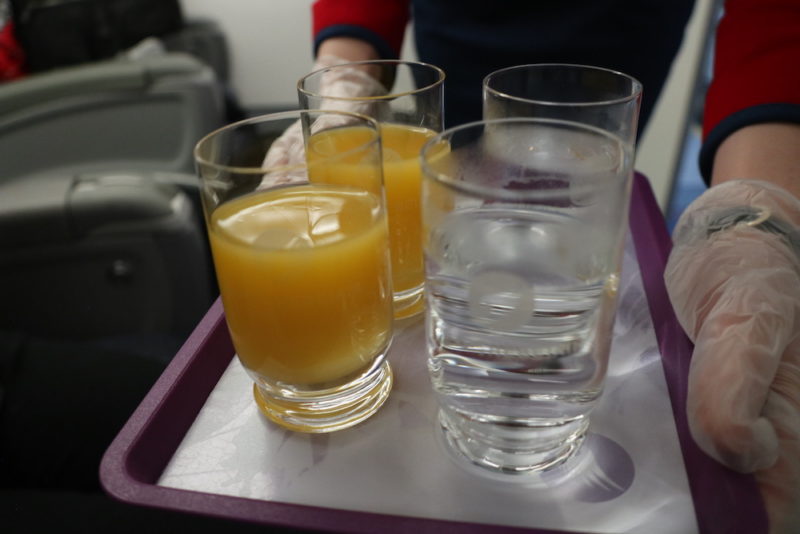 a tray with glasses of orange juice and water