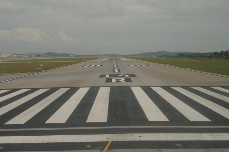 a runway with a crosswalk and grass