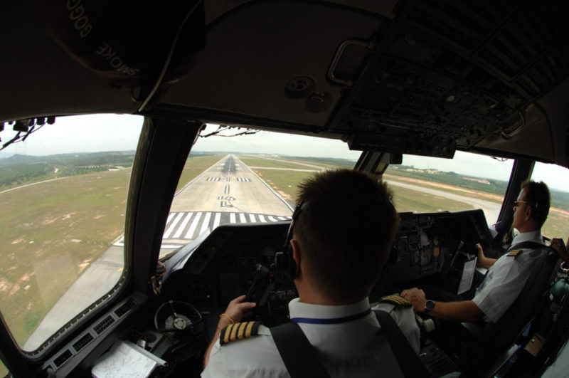 a man in uniform flying a plane