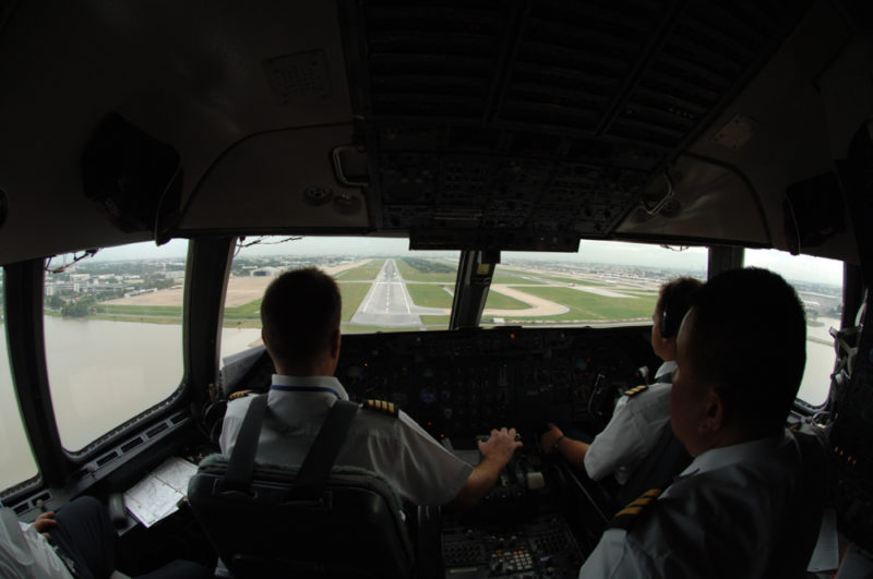 a group of pilots in the cockpit of an airplane