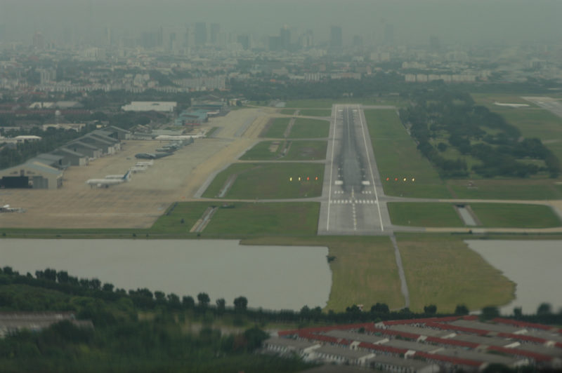 an aerial view of a runway and a city