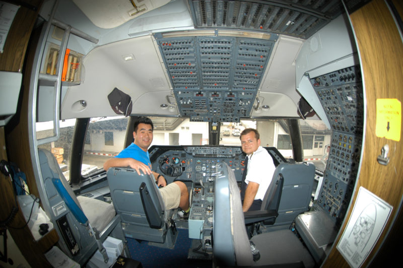 men sitting in the cockpit of an airplane