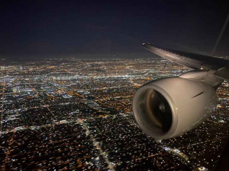 an airplane wing and a city at night