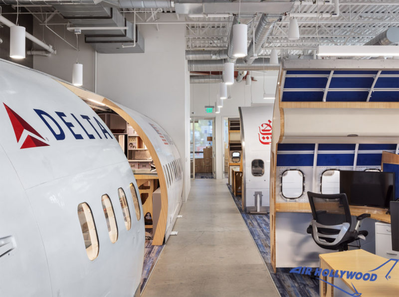 a room with white airplanes and a desk