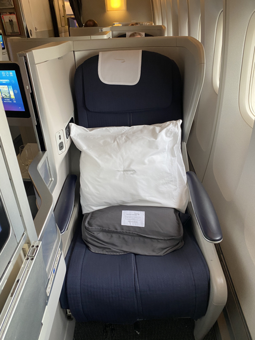 a seat with a pillow and a pillow in the middle of a plane