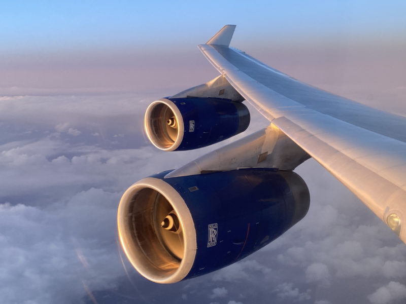 a plane wing with blue engines