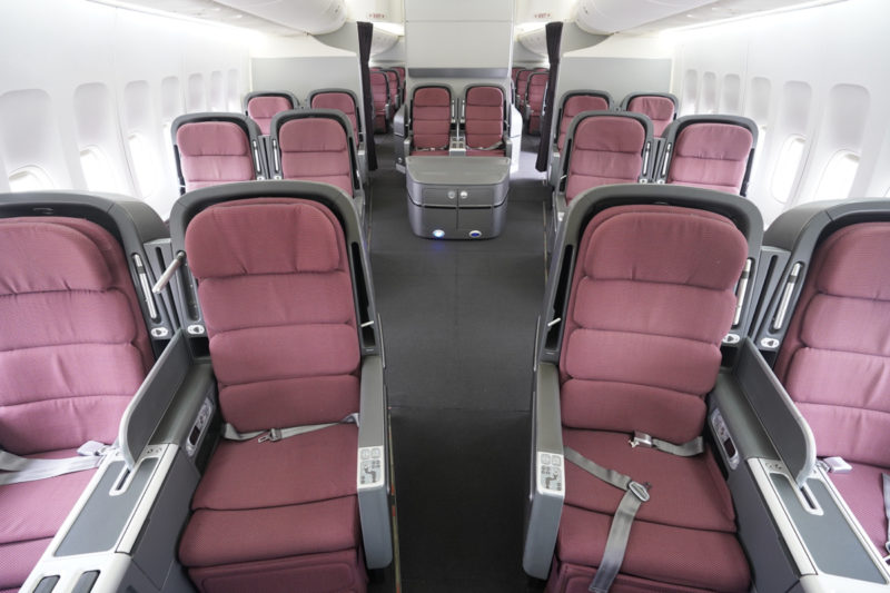 a row of red seats on an airplane