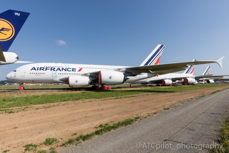 a group of airplanes parked on a runway