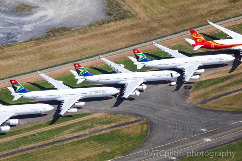 a group of airplanes on a runway