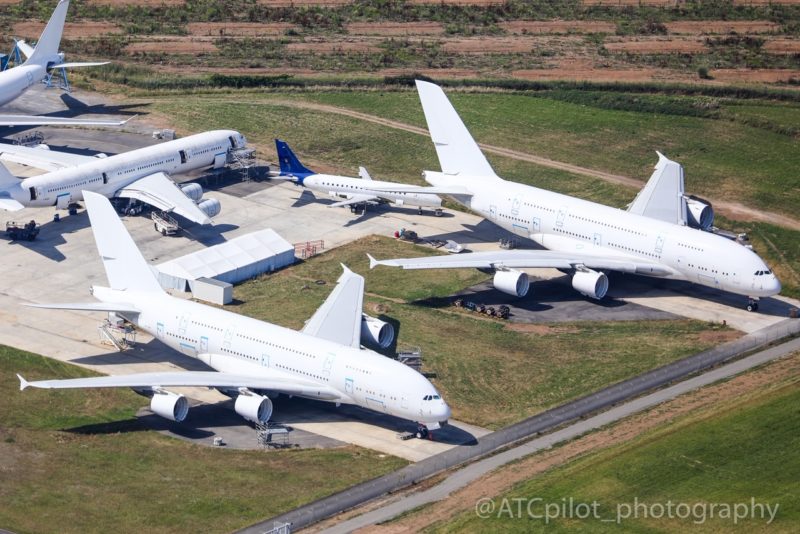 a group of white airplanes on a runway