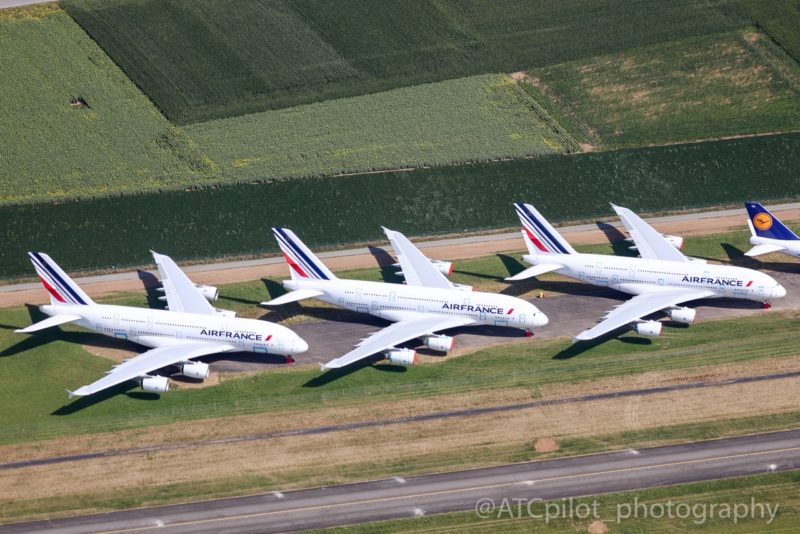 a group of airplanes on a runway