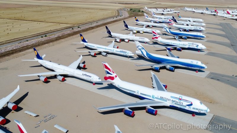 a group of airplanes parked on a runway