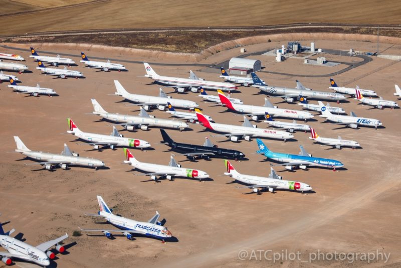 an aerial view of airplanes parked on a runway