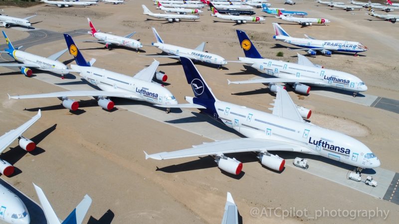 a group of airplanes parked on a runway