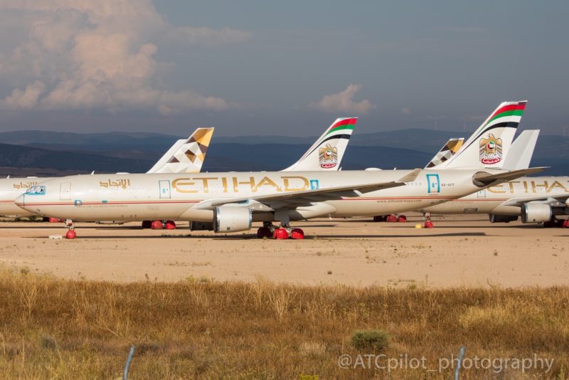 a group of airplanes on a runway