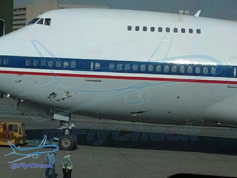 a large white airplane with red and blue stripes