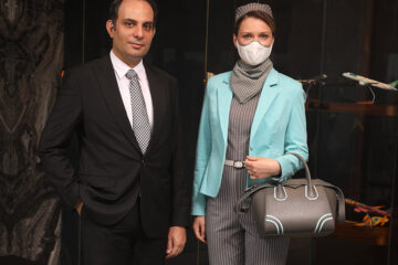 a man and woman wearing face masks