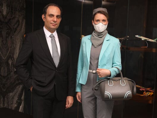 a man and woman wearing face masks
