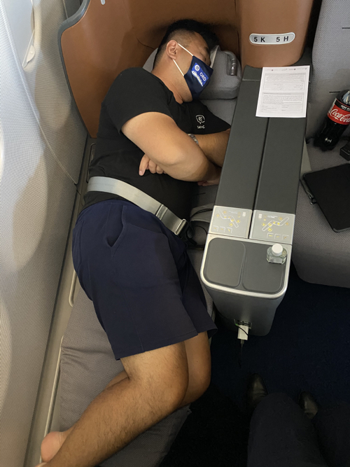a man sleeping on an airplane