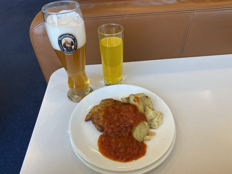 a plate of food and a glass of beer