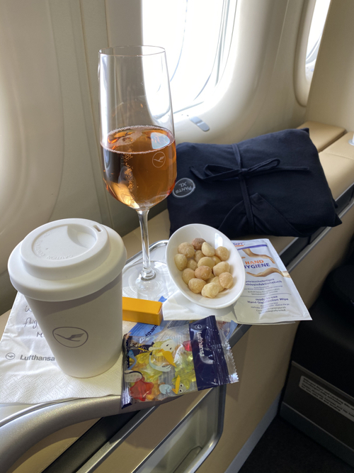 a glass of wine and snacks on a table