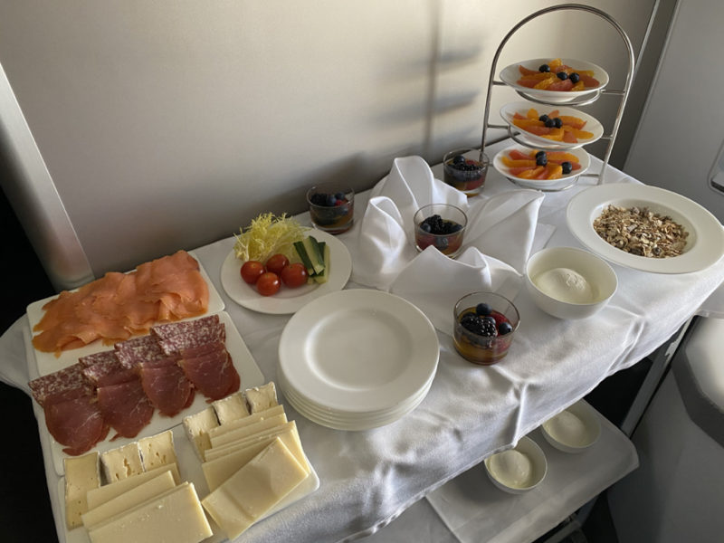 a table with plates of food and fruit on it