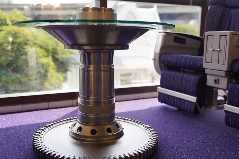 a round metal table with a glass top