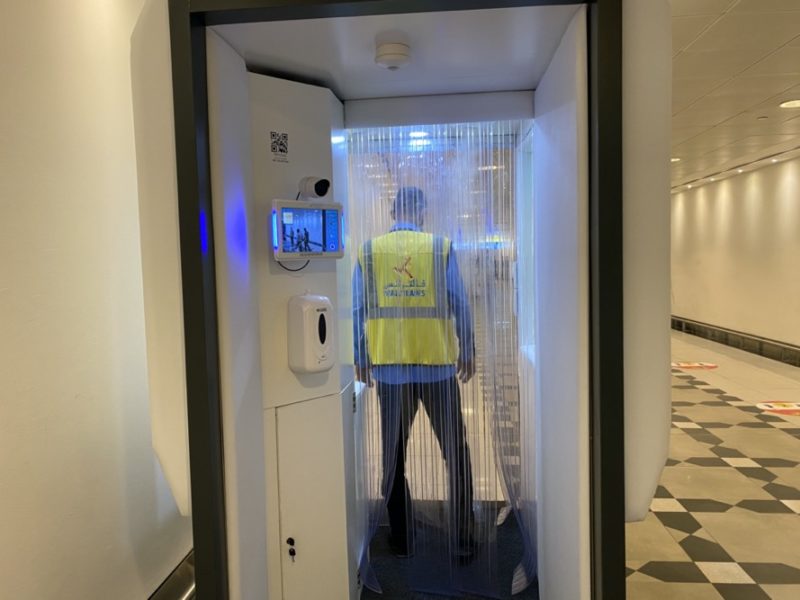 a man in a reflective vest standing in a room