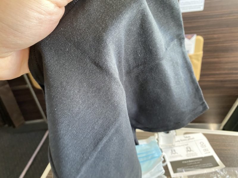 a hand holding a black cloth