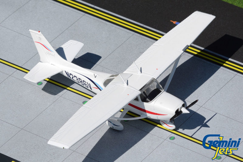 a small white airplane on a runway