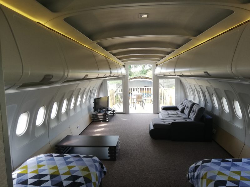 inside a plane with a couch and tables