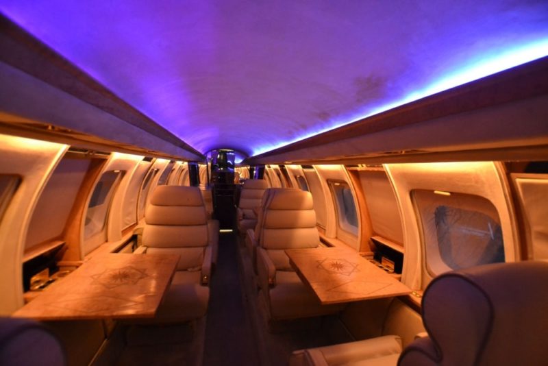 inside a plane with seats and tables