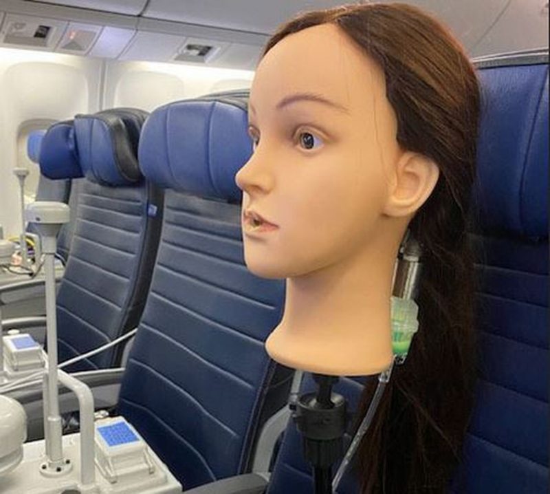 a mannequin head in a plane