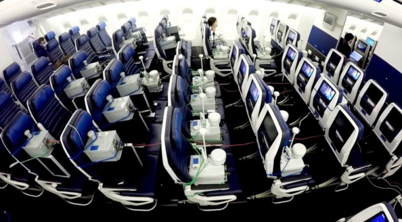 a room with rows of chairs and monitors