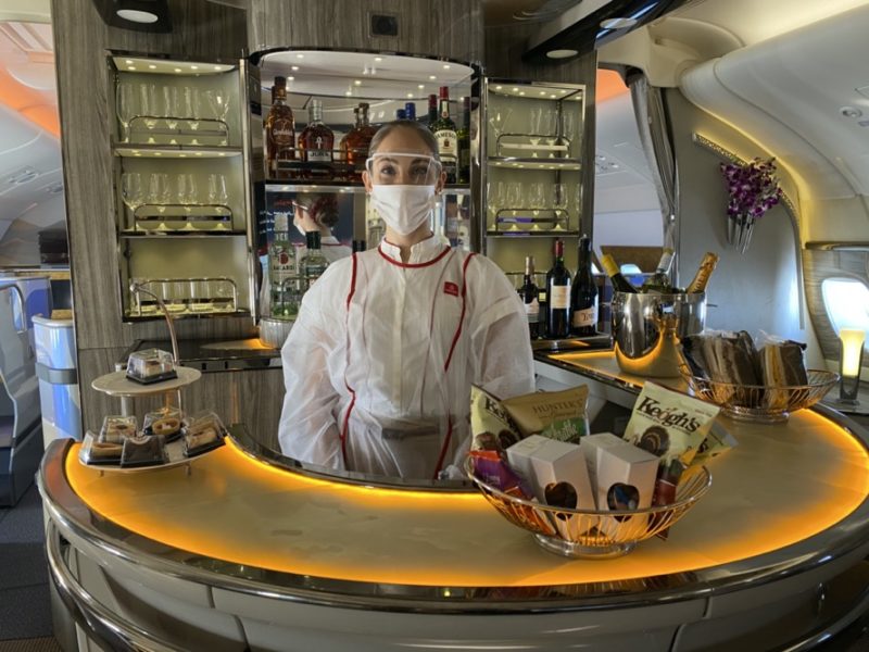 a woman wearing a face mask behind a counter