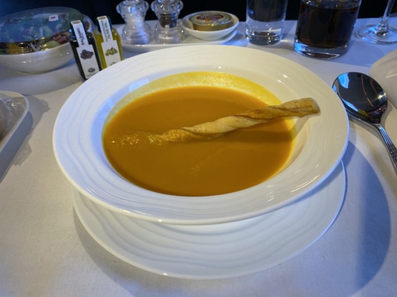 a bowl of soup with a stick in it