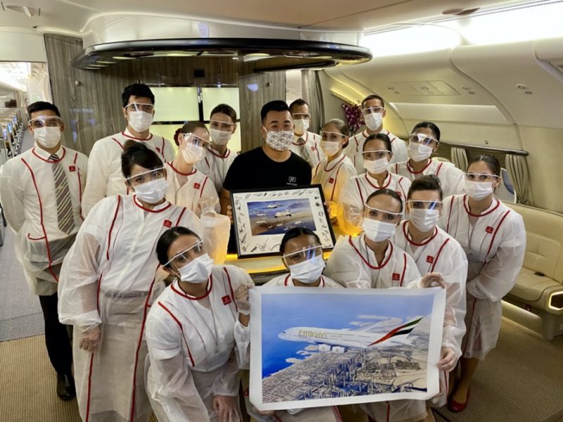 a group of people wearing face masks and standing in a plane