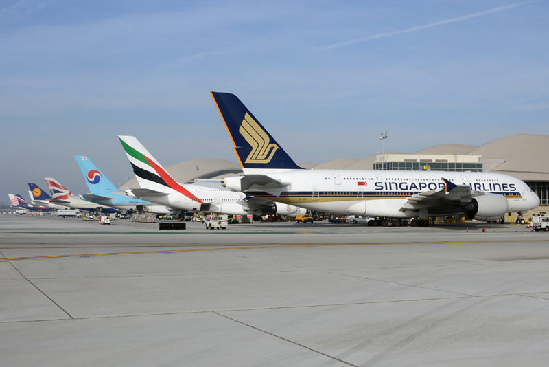 a group of airplanes parked on a runway