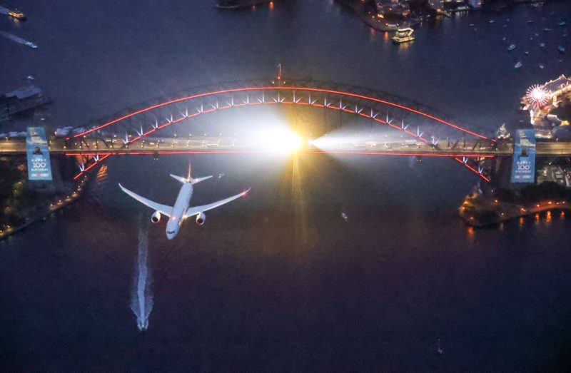 an airplane flying over a bridge