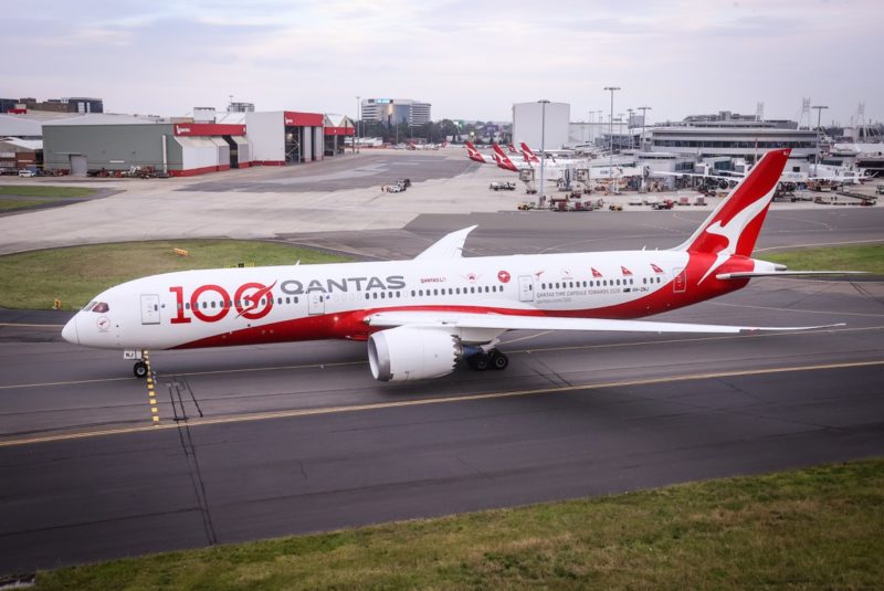 a large white and red airplane on a runway