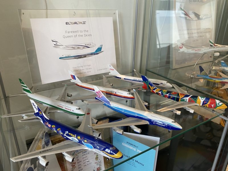 a group of model airplanes on a glass shelf